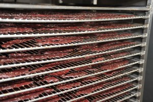 Freshly cooked jerky leaving the oven.