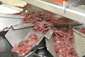 Portions fed to packaging carousel.
